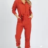 SKIES ARE BLUE NEW ARRIVALS DEEP RUST LONG SLEEVE UTILITY JUMPSUIT